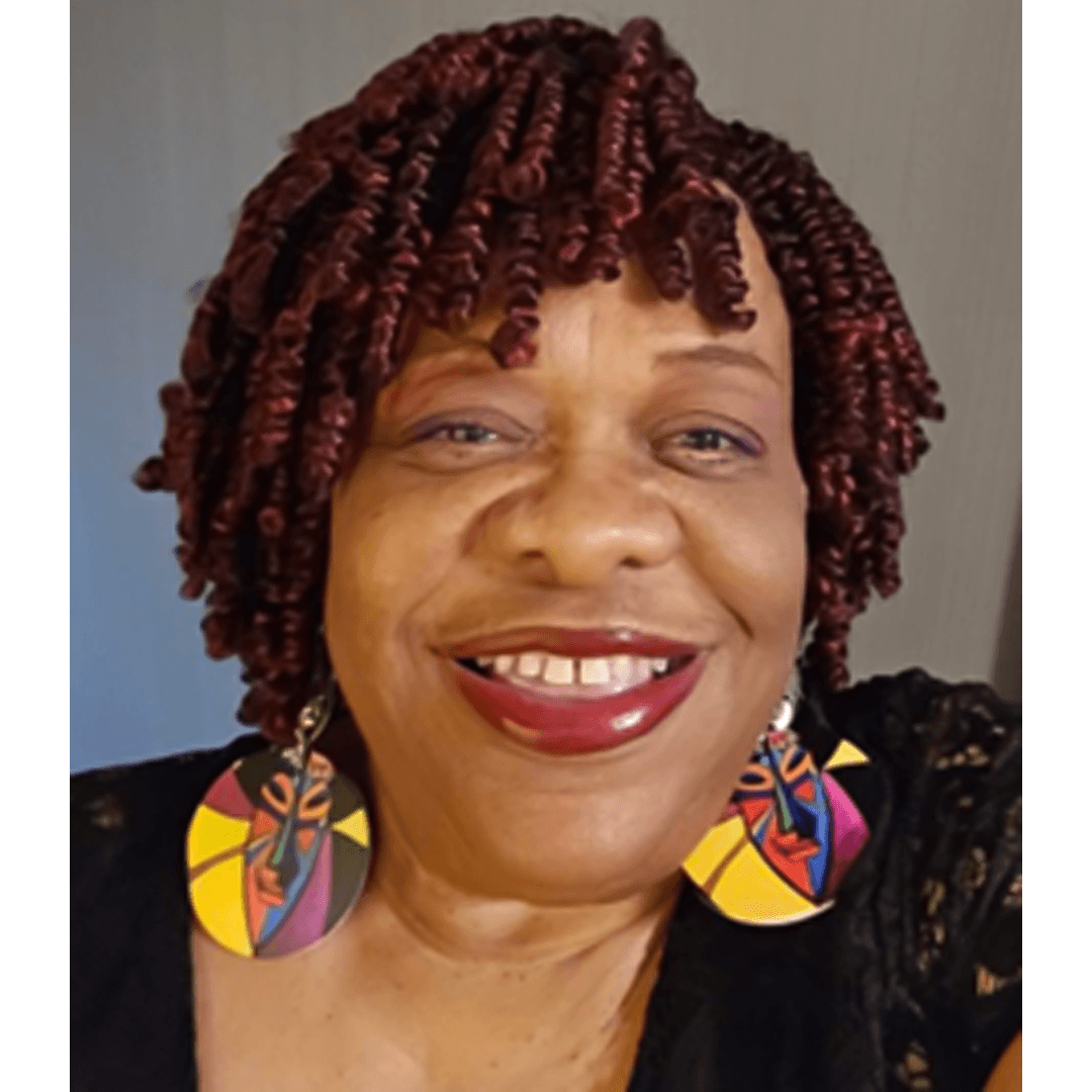 Smiling woman with colorful earrings.